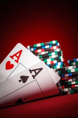 Live Sic Bo dealer shaking dice in a covered cup on a jamin table.